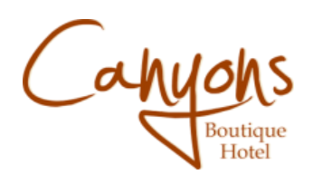 The logo displays the words “Canyons Boutique Hotel” in stylized brown script on a white background.